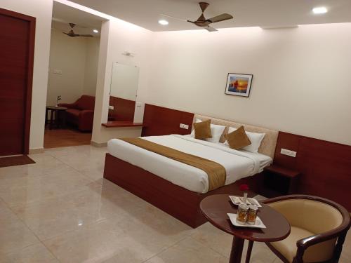 a hotel room with a bed and a table at CLIFFVIEW RESORT in Yercaud