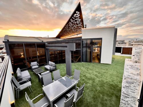 a house with a table and chairs on a roof at Granada Villas in Jericho