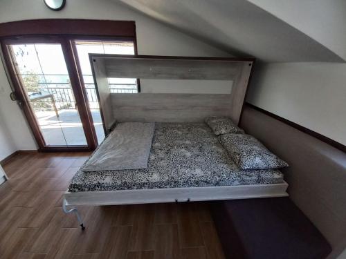 a large bed in a room with a window at Villa Ivan in Risan