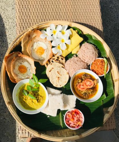 a plate of food with different types of food on it at Kiss Blossom in Mirissa