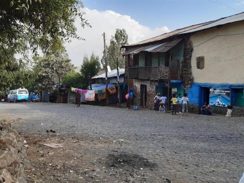 a group of people standing on a street next to a building at Lodge Du Chateau in Gonder