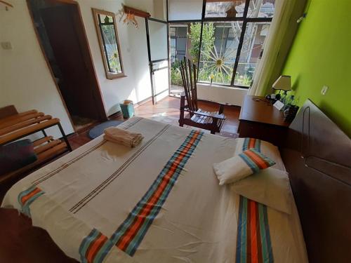a large bed in a room with green walls at Lodge Du Chateau in Gonder