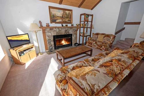 a living room with a couch and a fireplace at 3336 Pine Hill Road home in South Lake Tahoe