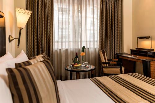 a hotel room with a bed and a desk at The Park Kolkata in Kolkata
