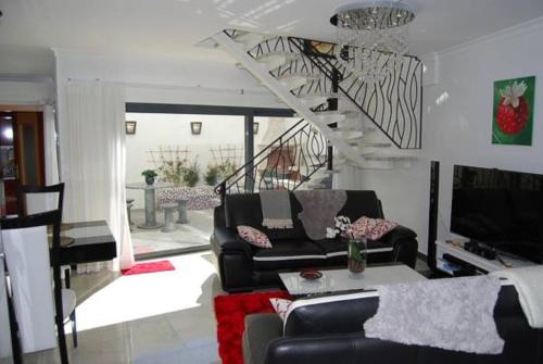 a living room with a couch and a table at The Birds Nest in Alvor