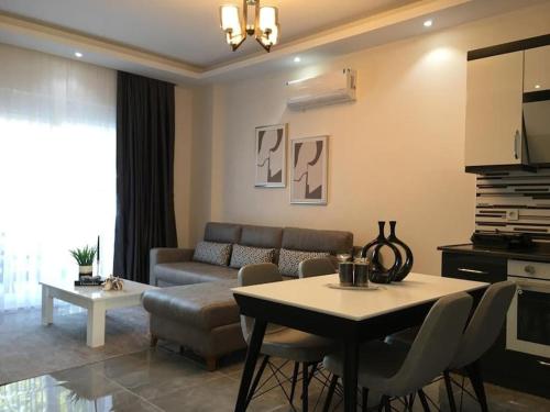 a living room with a couch and a table at 2 Zimmer Apartment in Avsallar in Alanya