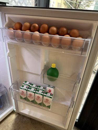 an open refrigerator filled with eggs and milk at Haru The Guesthouse in Andong