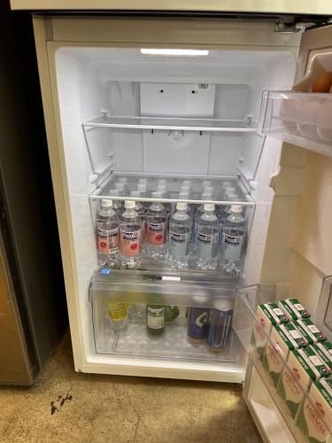 an open refrigerator filled with bottles of water at Haru The Guesthouse in Andong