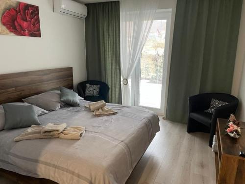 a bedroom with a bed with two towels on it at Apartmán Rose in Podhájska