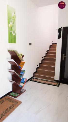 a staircase in a room with a book shelf at Airport Faith Hotel in Katunayake
