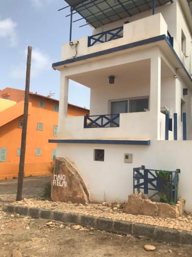 a white building with a sign on it at Maio Relax in Vila do Maio