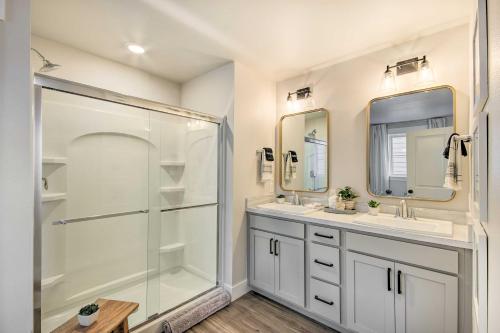 a bathroom with two sinks and a glass shower at Cozy Montana Retreat with Patio and Fire Pit! in Billings