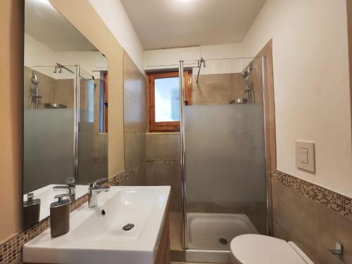 a bathroom with a sink and a shower and a toilet at Collins Apartments in Castellaneta Marina 