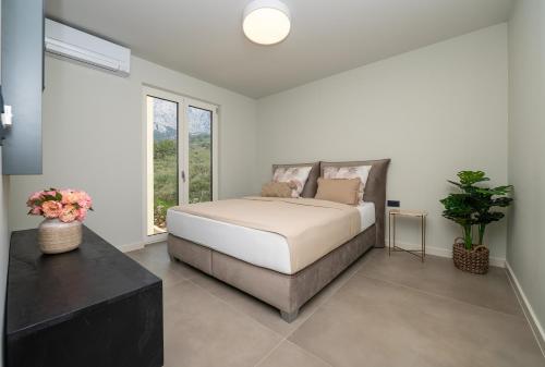 a bedroom with a bed and a large window at Apartment Adriatic Pearl -NEW 2023- in Tučepi
