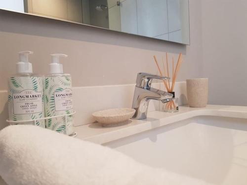 a bathroom sink with a faucet and a counter top at Luxury 1 bedroom apartment in vibrant Menlyn Maine in Pretoria