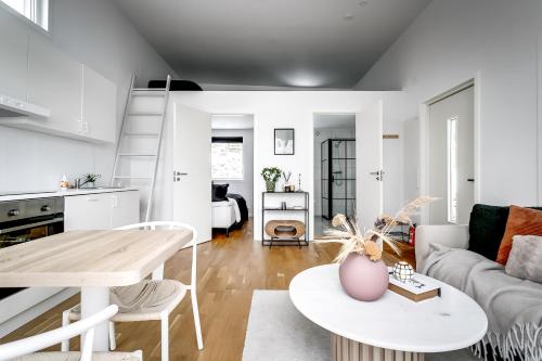 a living room with a couch and a table at Relaxing Lake Oasis with Jacuzzi - Amazing view & Private Pier in Stockholm