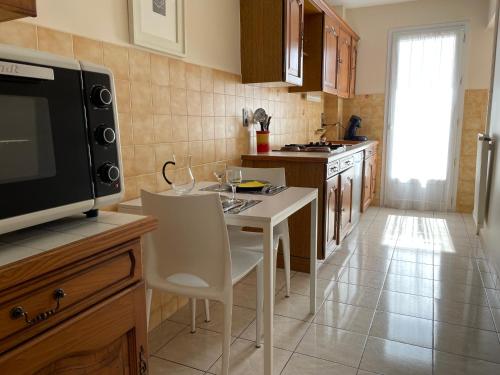 a kitchen with a small table and a microwave at Verdi 1 in Aix-en-Provence