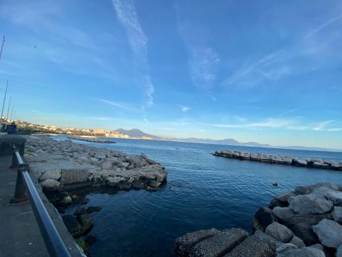 a large body of water with rocks in it at Maison Silvia in Naples