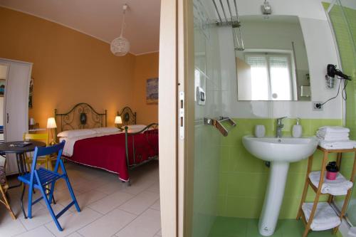 a bathroom with a sink and a bedroom with a bed at Al Sesto B&B in Salerno