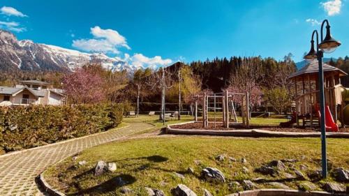 a park with a playground and a swing at Residence I LAMPONI incantevole trilocale casa vacanze 6 posti letto in Dimaro