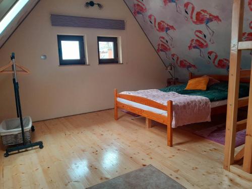 a bedroom with a bunk bed in a attic at Szmerkowa Chatynka z kominkiem i jacuzzi w Karkonoszach in Lubawka