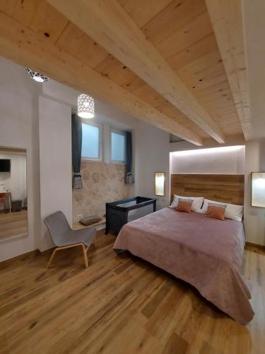 a bedroom with a large bed and a chair at Core Cagliari in Cagliari