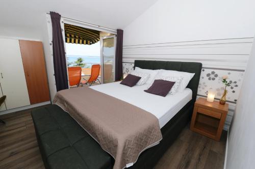 een slaapkamer met een groot bed en een raam bij Apartman Basioli1 in Zadar