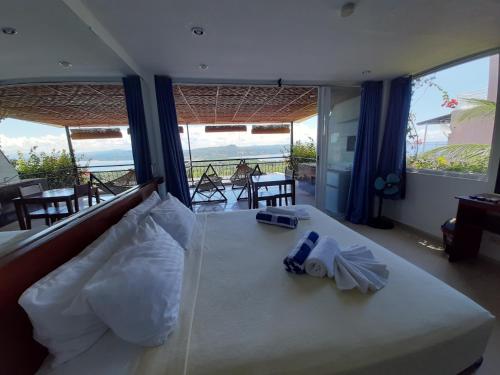 a bedroom with a bed with a view of the ocean at Bohol Vantage Resort in Panglao Island