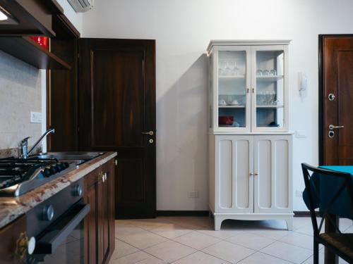 a kitchen with a white cabinet with dishes in it at Ca' Mazzega in Murano