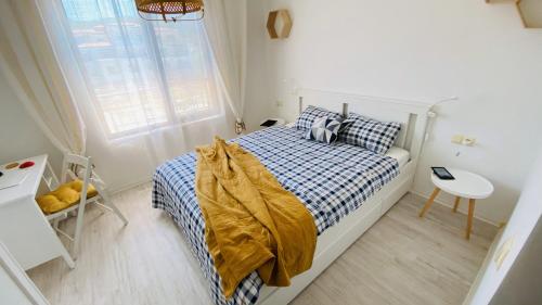 a small bedroom with a bed and a window at Lily Beach - Apartment 408A in Sozopol