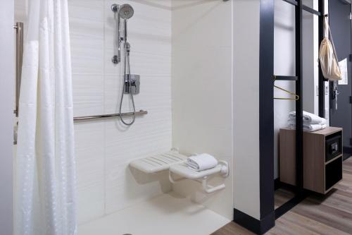 a bathroom with a toilet and a shower at Aloft Orlando Lake Buena Vista in Orlando