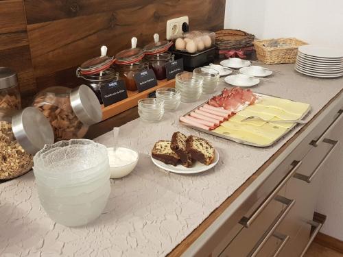 a counter with food and drinks on a table at Gästehaus Ferienglück Grainau in Grainau