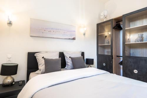 a bedroom with a white bed and a cabinet at JEAN MEDECIN - Modern and brand new 1Br flat in Nice