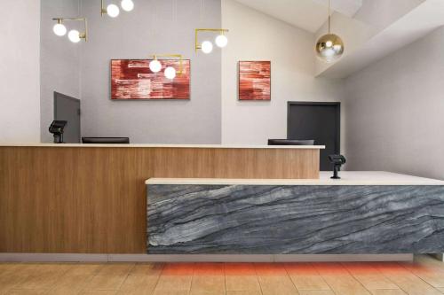a lobby with a marble counter top in a room at Ramada by Wyndham Allentown Bethlehem in Allentown