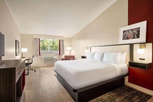 a hotel room with a bed and a desk at Ramada by Wyndham Allentown Bethlehem in Allentown