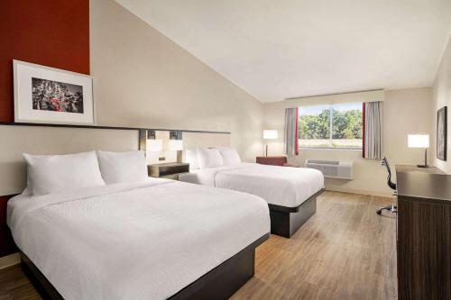 a hotel room with two beds and a window at Ramada by Wyndham Allentown Bethlehem in Allentown