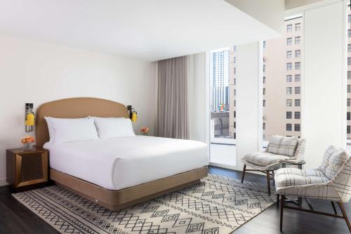 a bedroom with a bed and a large window at Hyatt Centric Congress Avenue Austin in Austin