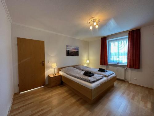 a bedroom with a large bed and a window at Heidhof in Bispingen