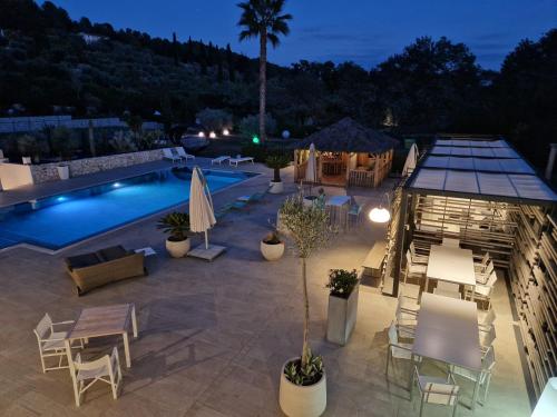 a patio with a pool and a table and chairs at Luxury Zen in Châteauneuf
