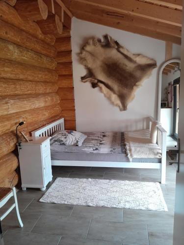 a bedroom with a bed and a wooden wall at Apartement Unten im Dorf 