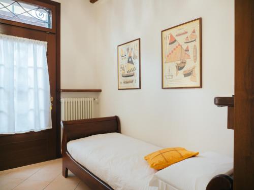 a bedroom with two beds and two pictures on the wall at Ca' Mazzega in Murano