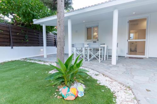 a white house with a palm tree in the yard at Katerlove Beach House in Faliraki