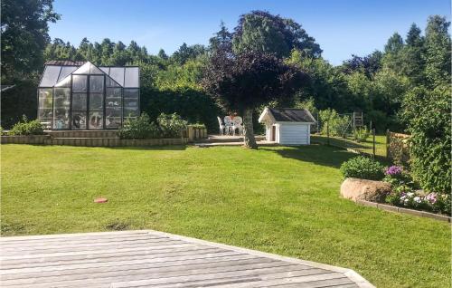 a group of people sitting in a yard with a house at Gorgeous Home In Uddevalla With Sauna in Uddevalla