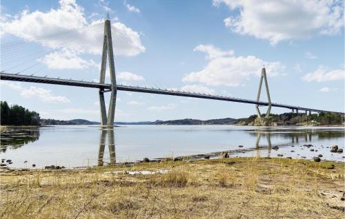 a suspension bridge over a river with water at Gorgeous Home In Uddevalla With Sauna in Uddevalla