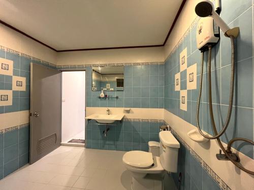 a bathroom with a toilet and a sink and a shower at Rose Garden Guest House Soi 88 Hua Hin in Hua Hin
