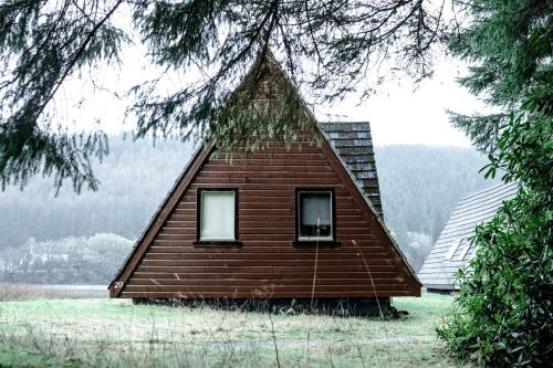 a house with a triangular roof with two windows at The Triangle Lodge in Invergarry