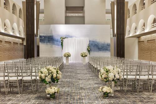 a wedding altar in a hall with chairs and flowers at Boston Marriott Long Wharf in Boston