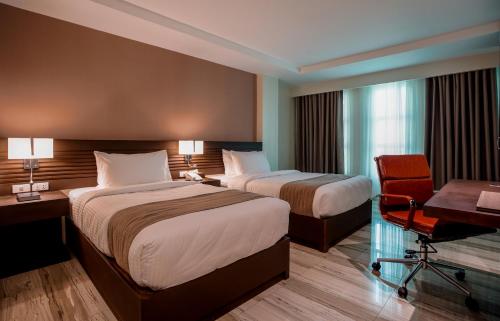 En eller flere senger på et rom på Hotel Areca