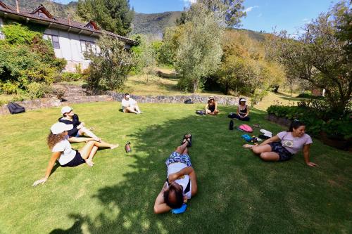 a group of people sitting in the grass at Nalanda SPA & Casa de Montaña in Patate