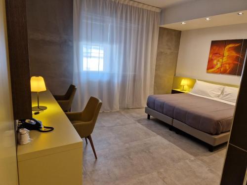 Ένα ή περισσότερα κρεβάτια σε δωμάτιο στο Korè Hotel